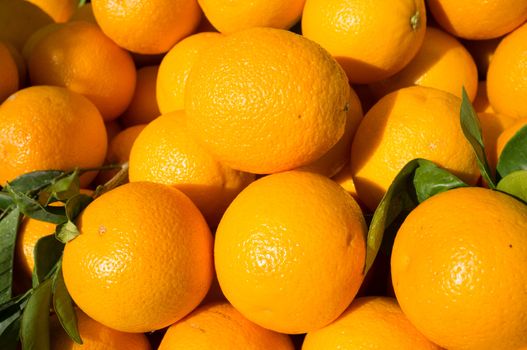 Full frame take of oranges displayed on a market stall