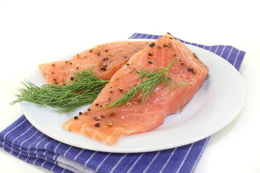 two raw pieces of salmon with dill