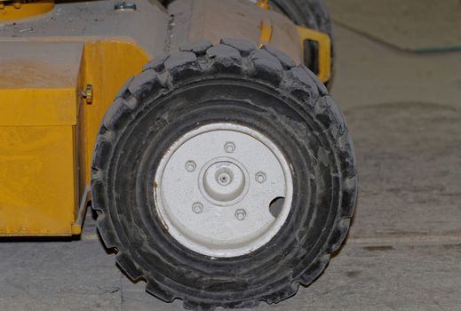 Yellow industrial machine with solid rubber wheel