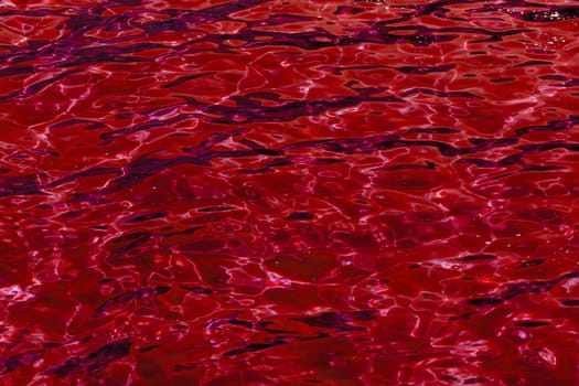 red abstract background of wavy water surface