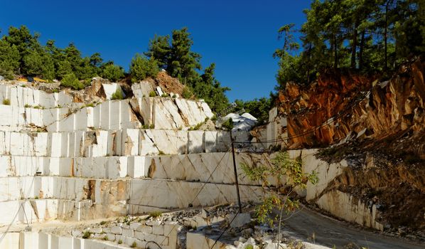 Detail of huge Thassos white marble quarry (mine) with grabber