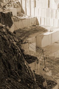 Detail of huge Thassos white marble quarry (mine) with grabber sepia