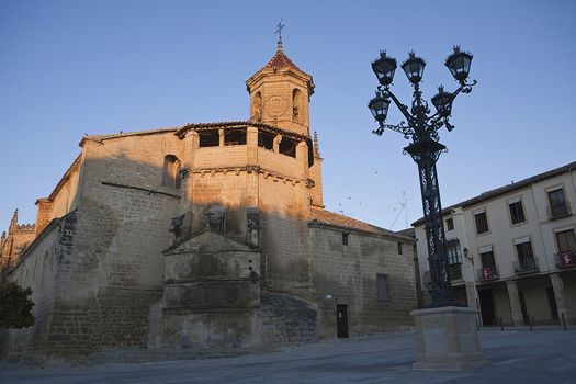 Square on May 1, with side front and source of the church of San pablo and lamppost, Ubeda,Jaen province, Spain