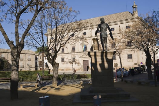 Statue of Vandelvira with city hall in the background, Vazquez de Molina Square, Ubeda, Jaen province, Spain