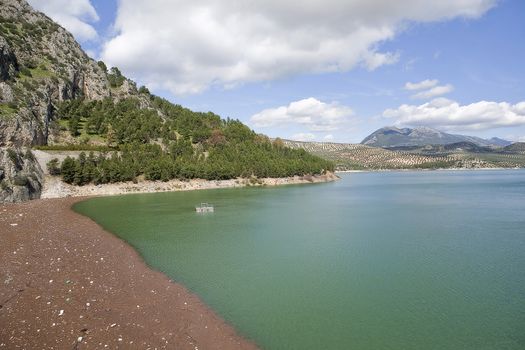 It was inaugurated on June 3, 1969, and belongs to the Guadalquivir hydrographic Confederation. The main tributary of the river Guadalquivir, the Genil, becomes Iznajar in the largest swamp in Andalusia.