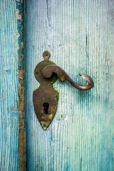 Antique Doorknob on a light blue wooden door