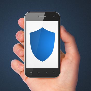 Protection concept: hand holding smartphone with Shield on display. Mobile smart phone on Blue background, 3d render