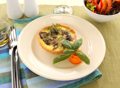 Fresh baked mushroom quiche straight from the oven is served.