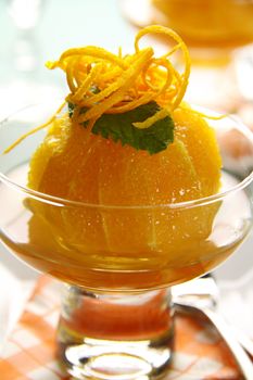 Delicious orange dessert with syrup topped with orange rind.