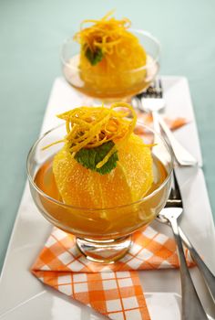 Delicious orange dessert with syrup topped with orange rind.