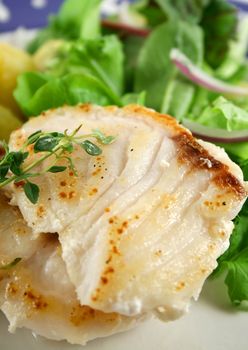 Pan fried Pearl Perch with golden roasted potato pieces and salad.