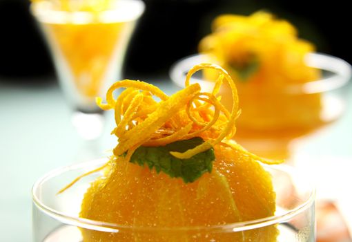 Delicious orange dessert with syrup topped with orange rind.