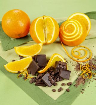 Decoratively prepared navel oranges with blocks and shards of dark chocolate.