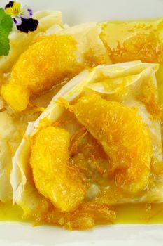Delicious orange crepes with citrus ice cream and custard creme.