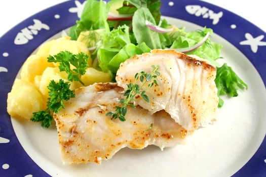 Pan fried Pearl Perch with golden roasted potato pieces and salad.