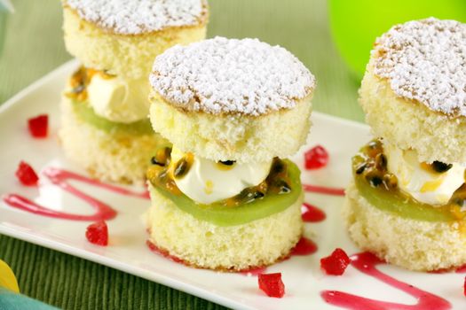 Delicious passionfruit sponge cake stacks served witha strawberry sauce.