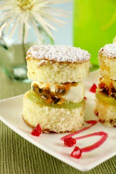 Delicious passionfruit sponge cake stacks served witha strawberry sauce.