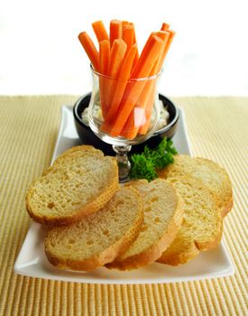 Crisp toasts with pineapple ricotta spread with julienne carrots.