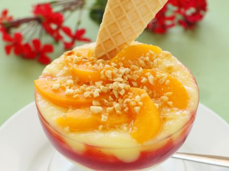 Delicious peach custard with raspberry sauce ready to serve.