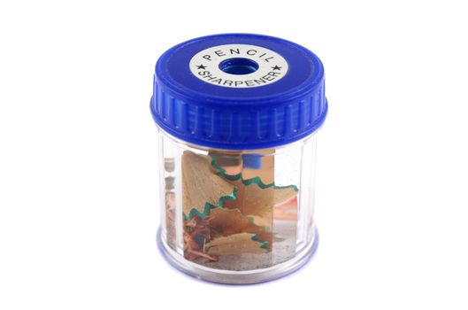 Plastic pencil sharpener with pencil and lead shavings in it.