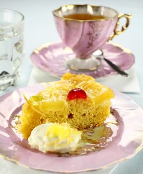 Fresh baked pineapple upside down cake with glace cherries.