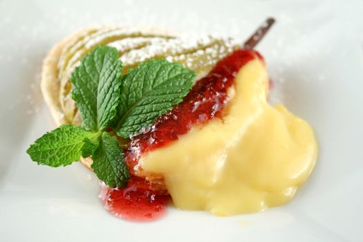 Delicate pear tartlets with custard and strawberry jam.