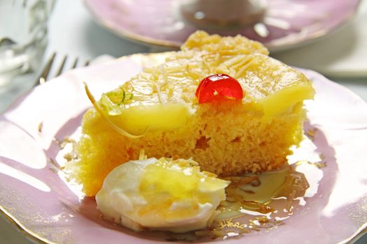 Fresh baked pineapple upside down cake with glace cherries.