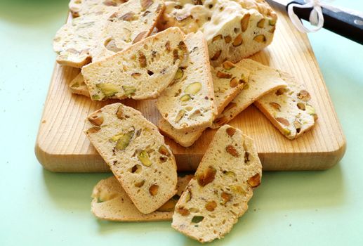 Fresh baked sweet pistachio bread sliced on a bread board ready to serve.