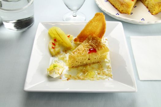 Fresh baked pineapple upside down cake with glace cherries.