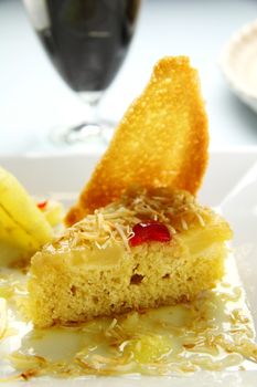 Fresh baked pineapple upside down cake with glace cherries.