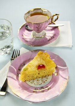 Fresh baked pineapple upside down cake with glace cherries.