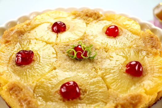 Fresh baked pineapple upside down cake with glace cherries.