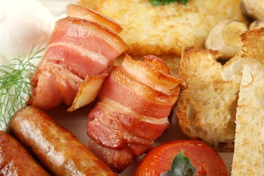 Ploughmans big breakfast of sausages, bacon, eggs, tomato and toast.