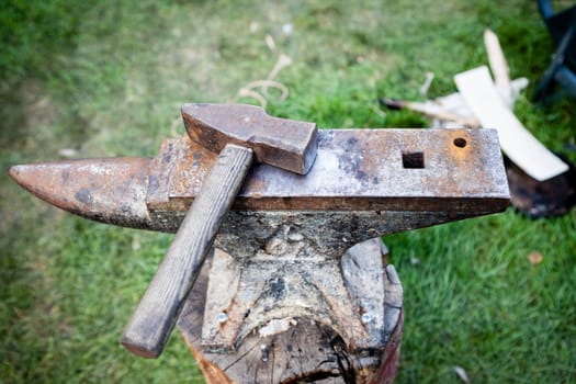 Rusty iron anvil and hammer