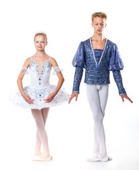 Couple of young ballet dancers posing over isolated white background