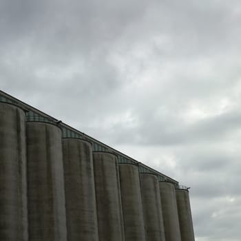 Large dark factory against grey sky