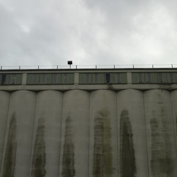 Large dark factory against grey sky
