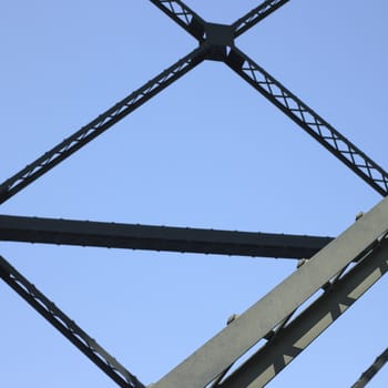 Heavy iron raillway bridge agains blue sky