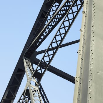 Heavy iron raillway bridge agains blue sky