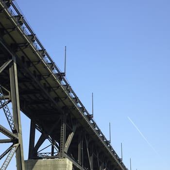 Heavy iron raillway bridge agains blue sky