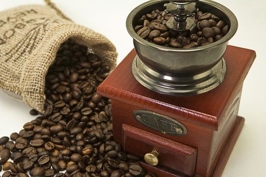 Roasted coffee beans are ground in a coffee grinder