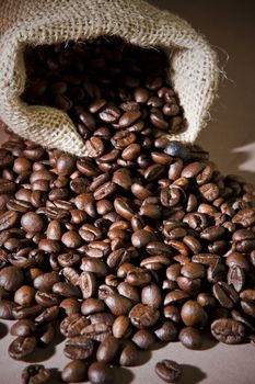Coffee beans in sack, burlap background