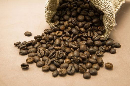 Coffee beans in sack, burlap background