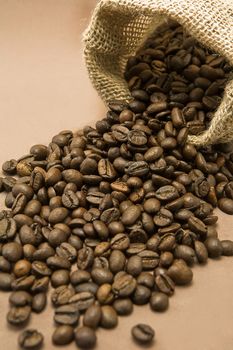 Coffee beans in sack, burlap background