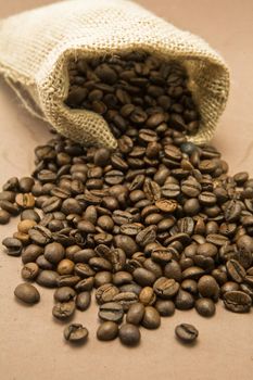 Coffee beans in sack, burlap background