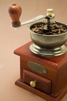 Roasted coffee beans are ground in a coffee grinder