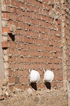 Two construction worker helmet hung on a wall, Spain