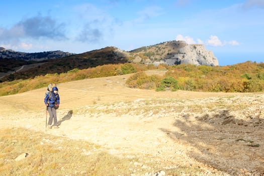 Tourist with backpacks go to the mountains
