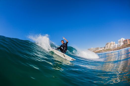 Close water action of surfer surfing clean ocean wave at Balito Bay north of Durban