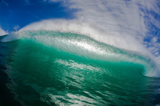 Hollow ocean wave crashing pitching forwards towards swimmers water position angle.